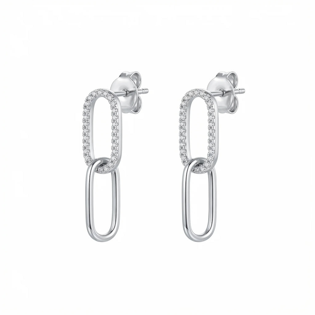 Double link silver earrings with clear stones on the top loop photographed in Dubai on a white background.
