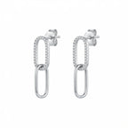 Double link silver earrings with clear stones on the top loop photographed in Dubai on a white background.