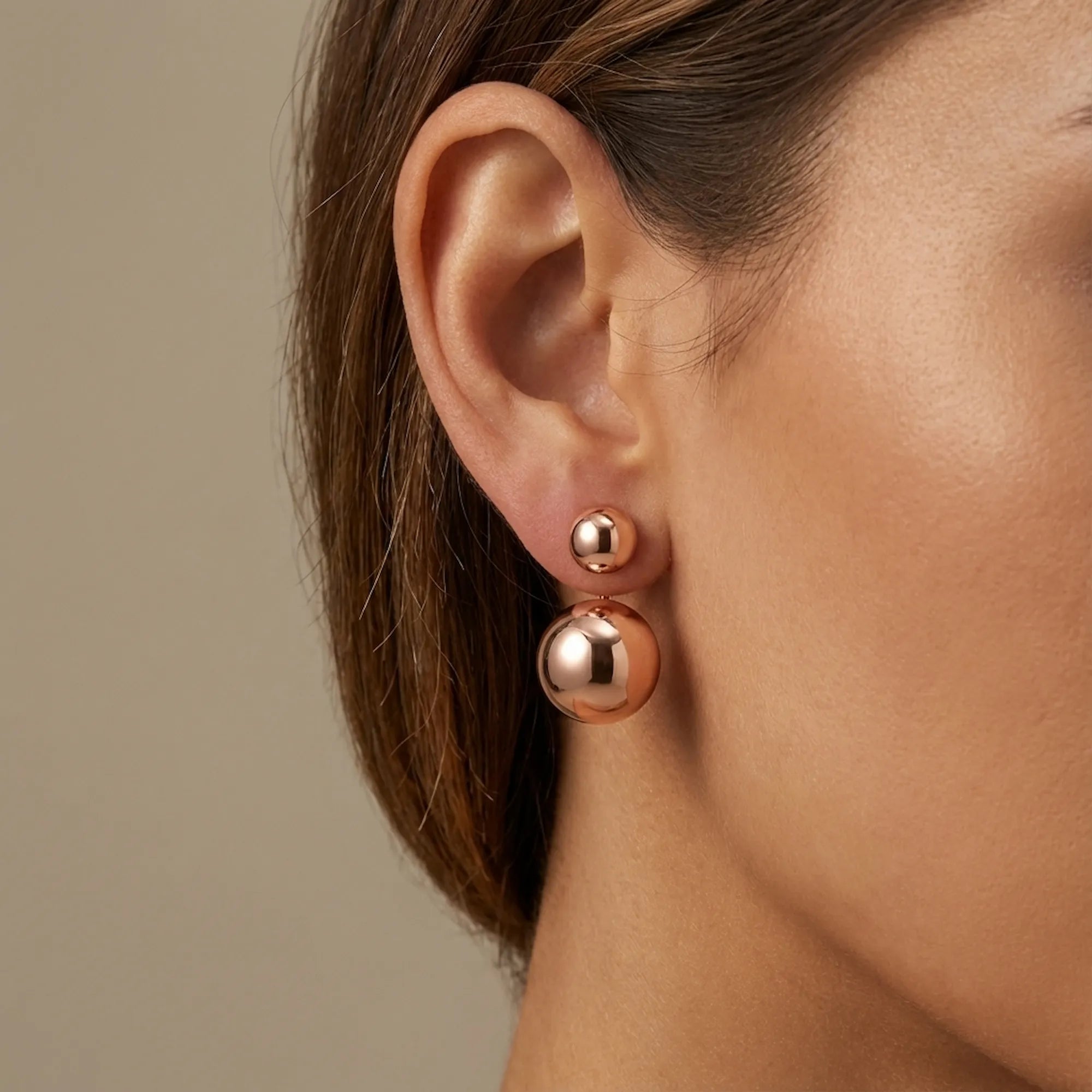 Ear close-up wearing full 2-in-1 double sphere earrings — rose gold 925 silver, both spheres worn together