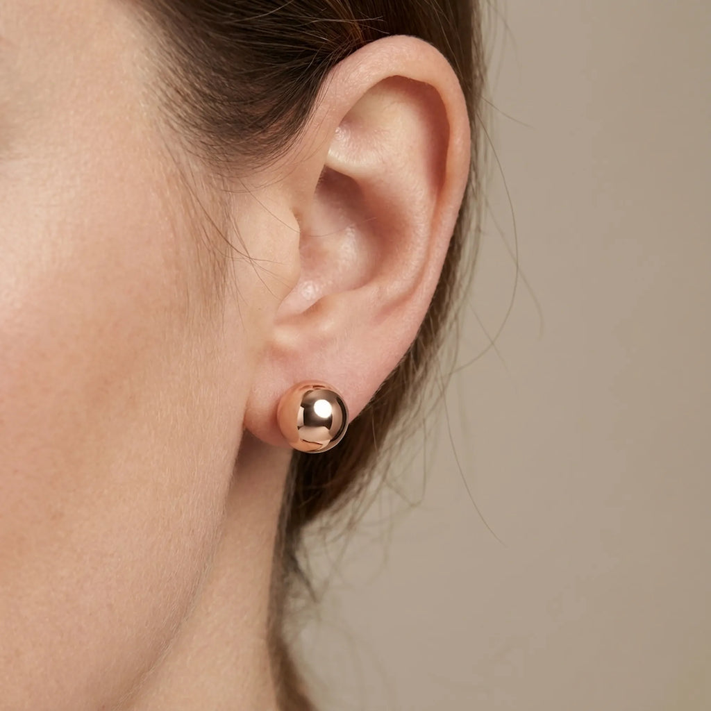 Ear close-up stud-only mode — 12mm rose gold 925 silver sphere worn alone, front ball single stud