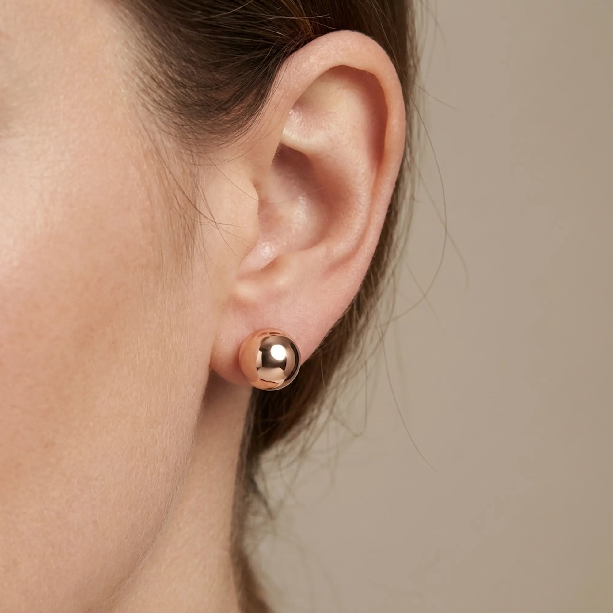 Ear close-up stud-only mode — 12mm rose gold 925 silver sphere worn alone, front ball single stud