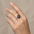 View of the deep blue November birthstone ring worn on a hand over linen, showcasing everyday wear of this sterling silver jewelry.