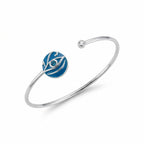 Evil eye cuff bangle, azure blue enamel with blue topaz, 925 sterling silver, white background