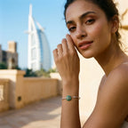 Woman wearing green peridot evil eye cuff bangle near Burj Al Arab hotel, Dubai, Luna Dura