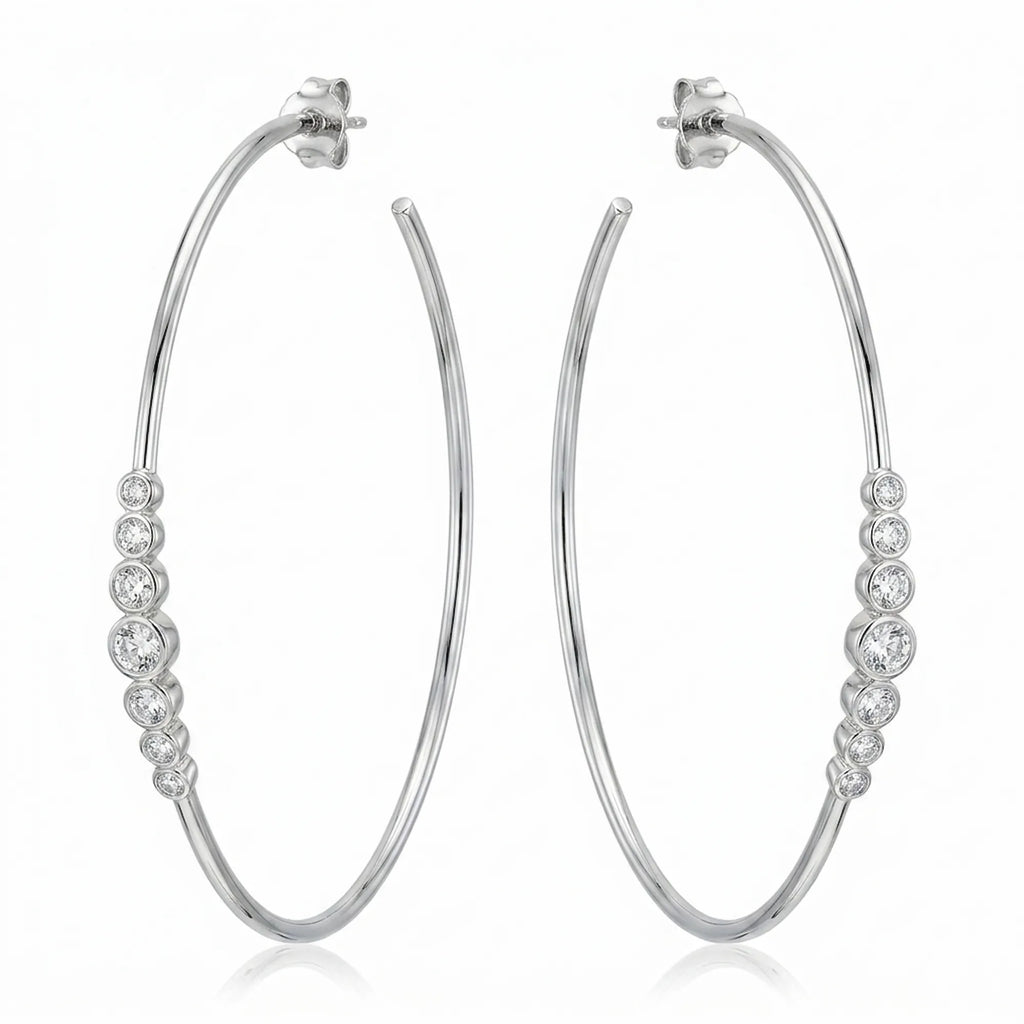 Pair of 70 mm rhodium-finished 925 silver hoop earrings with graduated bezel cubic zirconia. Luna Dura.