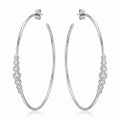 Pair of 70 mm rhodium-finished 925 silver hoop earrings with graduated bezel cubic zirconia. Luna Dura.