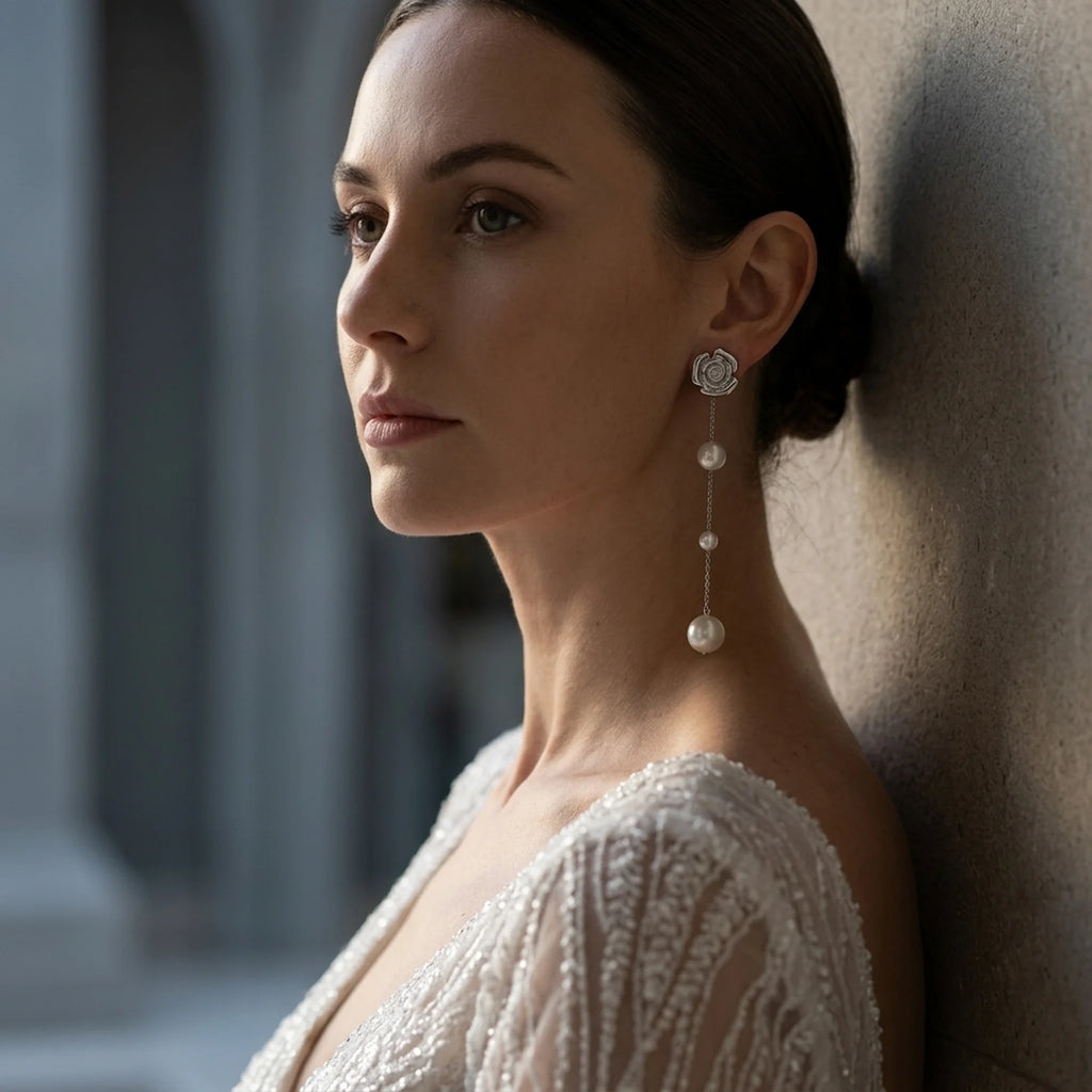 Bride wearing extra long 925 silver rose and faux pearl drop earrings for a wedding ceremony in Dubai.