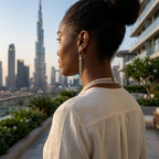 Woman wearing extra long 925 silver tassel dangle earrings with the Burj Khalifa in Dubai.
