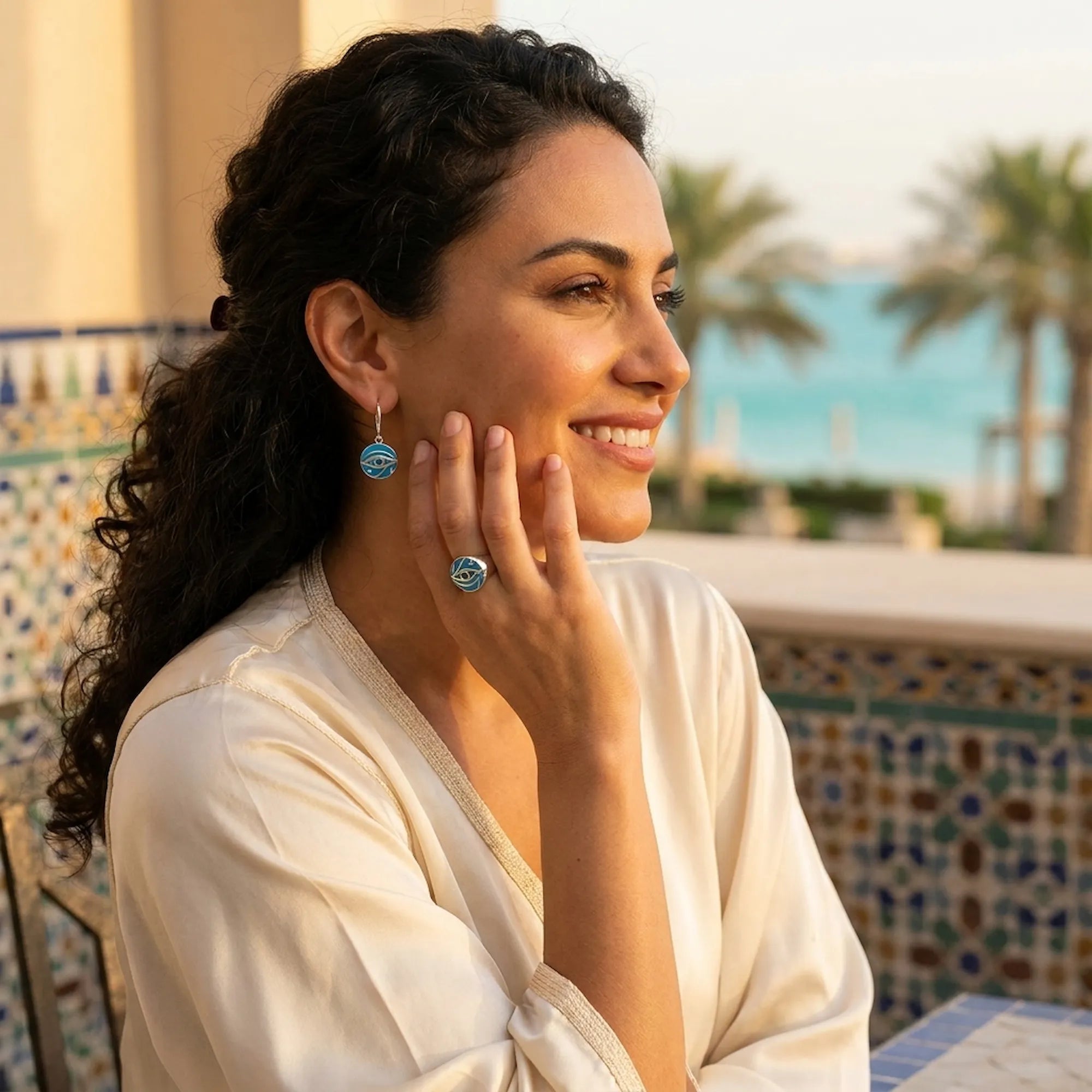 Woman wearing Eye of Horus enamel ring and earrings set at Jumeirah Al Qasr, Madinat Jumeirah, Dubai