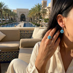 Eye of Horus azure topaz earring and ring set worn at Madinat Jumeirah resort poolside, Dubai