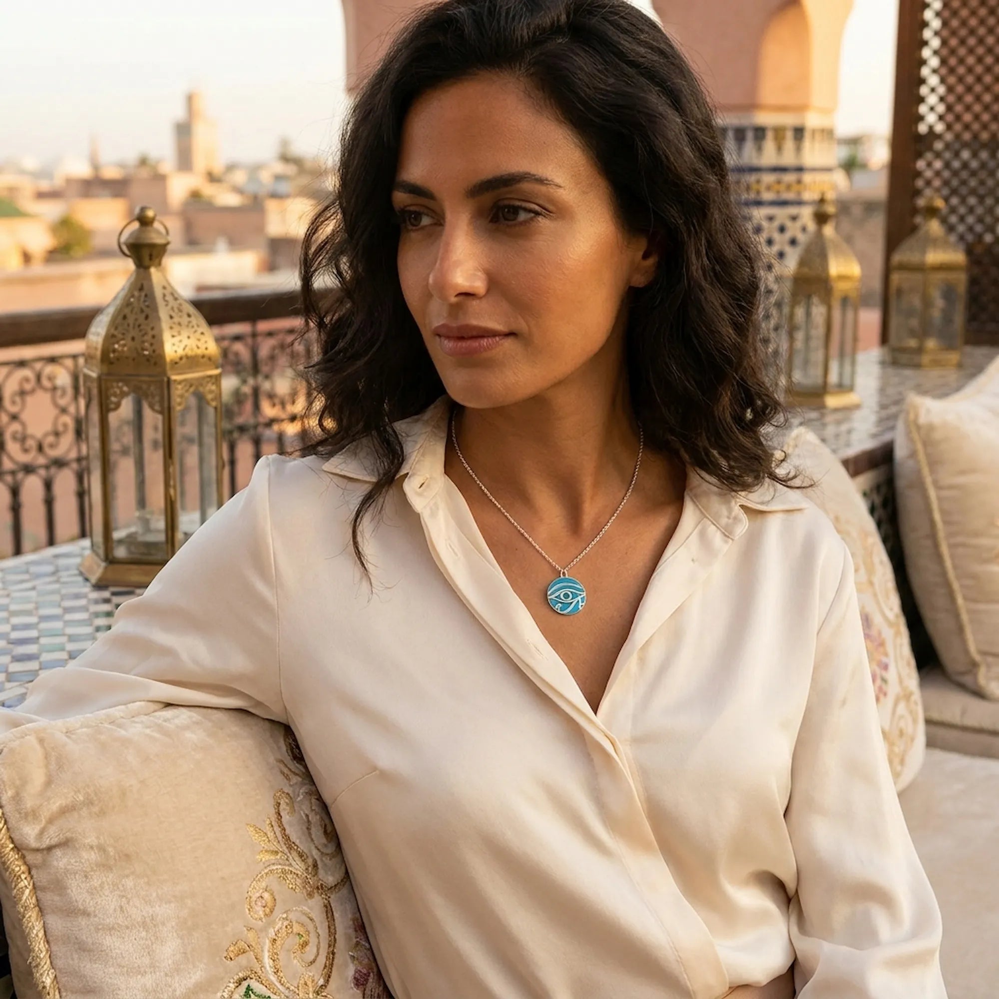 Woman wearing Eye of Horus azure topaz necklace at Bab Al Shams desert resort, Dubai