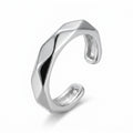 Rhodium 925 silver faceted band ear cuff for non-pierced wear, beside a velvet box on marble. Luna Dura Dubai.
