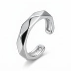 Rhodium 925 silver faceted band ear cuff for non-pierced wear, beside a velvet box on marble. Luna Dura Dubai.