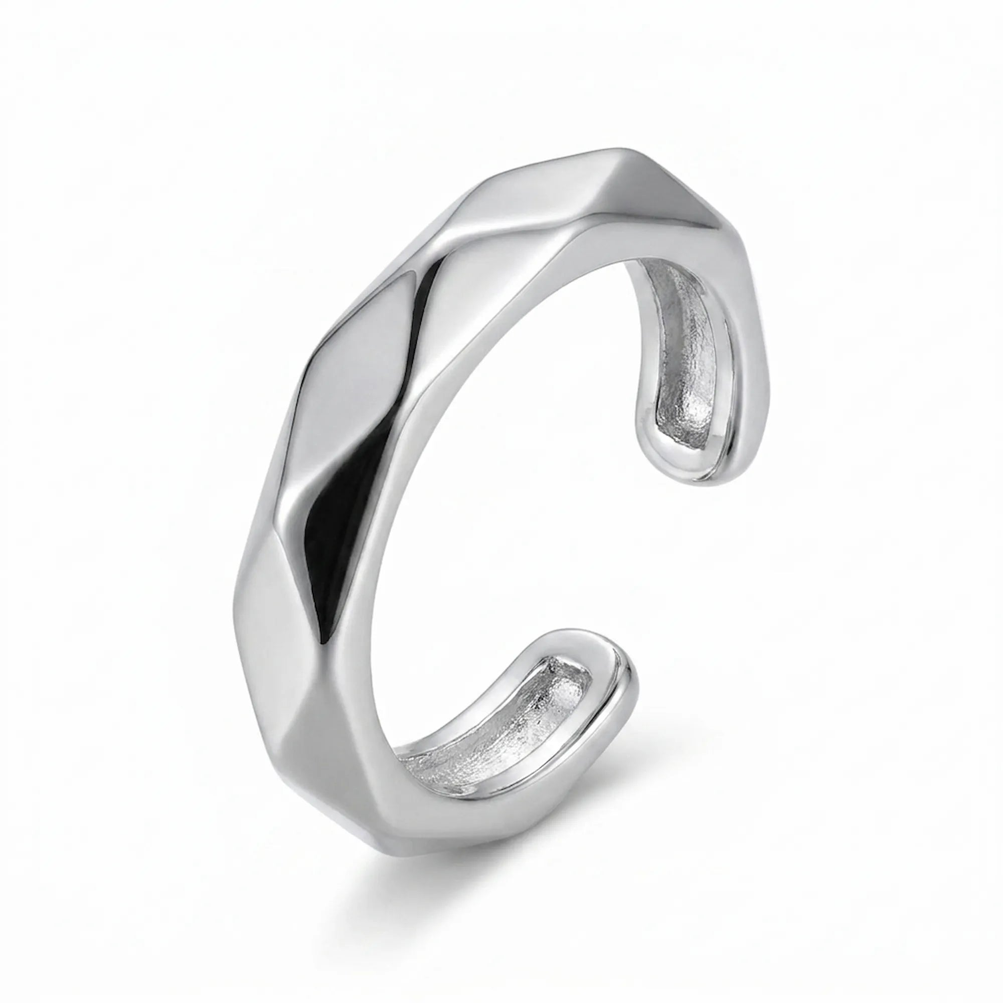 Rhodium 925 silver faceted band ear cuff for non-pierced wear, beside a velvet box on marble. Luna Dura Dubai.