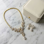 18k gold-plated cubic zirconia floral Y-necklace set styled with a jewelry gift box on a marble table indoors in Dubai.