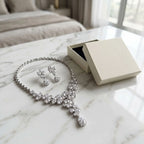 Rhodium-plated cubic zirconia floral Y-necklace set styled with a jewelry gift box on a marble table indoors in Dubai.