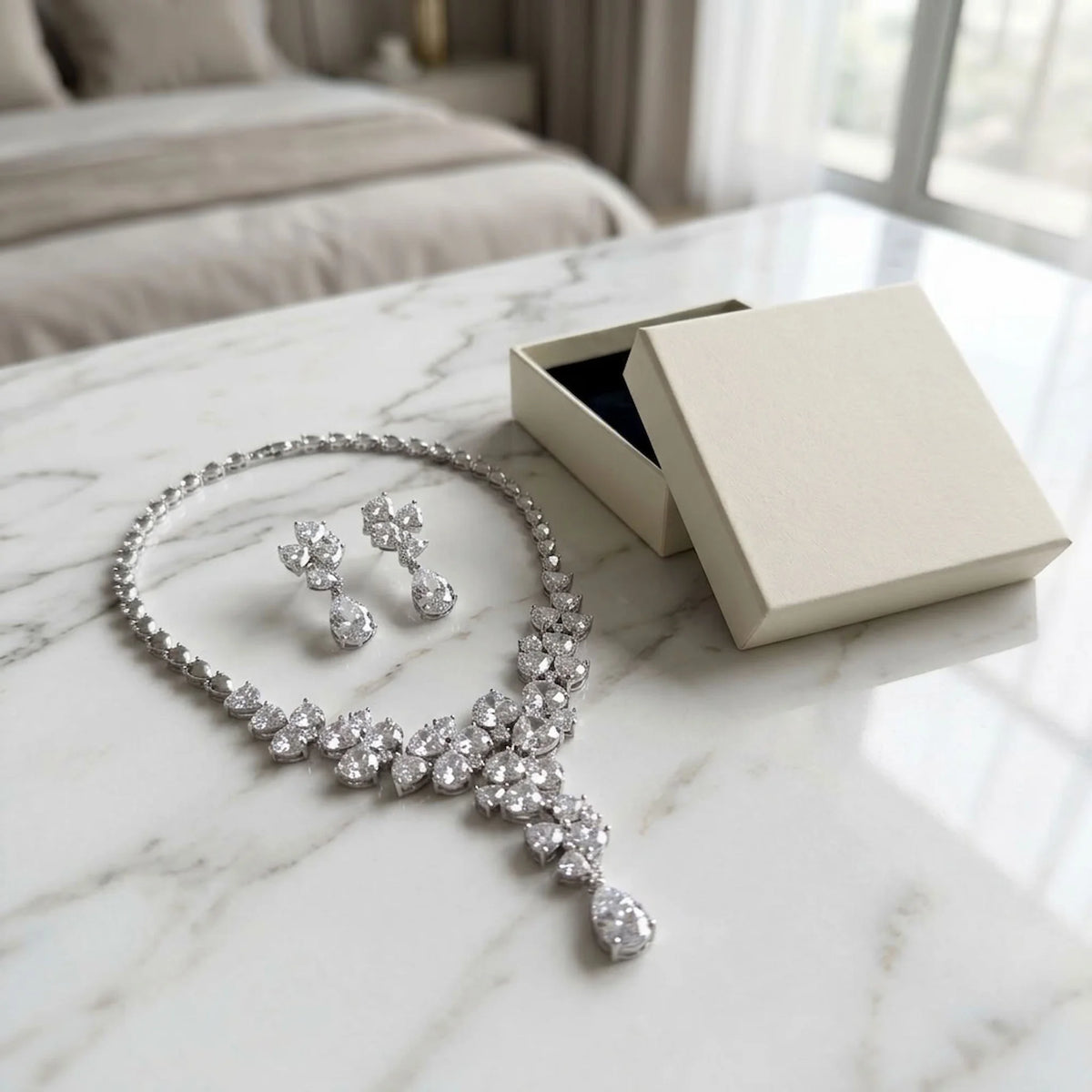 Rhodium-plated cubic zirconia floral Y-necklace set styled with a jewelry gift box on a marble table indoors in Dubai.