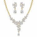 Floral cluster Y-drop necklace and earring set in 18k gold-plated cubic zirconia, displayed on a white stand in Dubai.