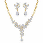 Floral cluster Y-drop necklace and earring set in 18k gold-plated cubic zirconia, displayed on a white stand in Dubai.