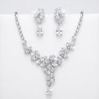 Floral cluster Y-drop necklace and earring set in rhodium-plated cubic zirconia, displayed on a white stand in Dubai.