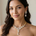 Woman wearing a bridal floral cluster Y-drop necklace and matching cubic zirconia earrings indoors in Dubai.