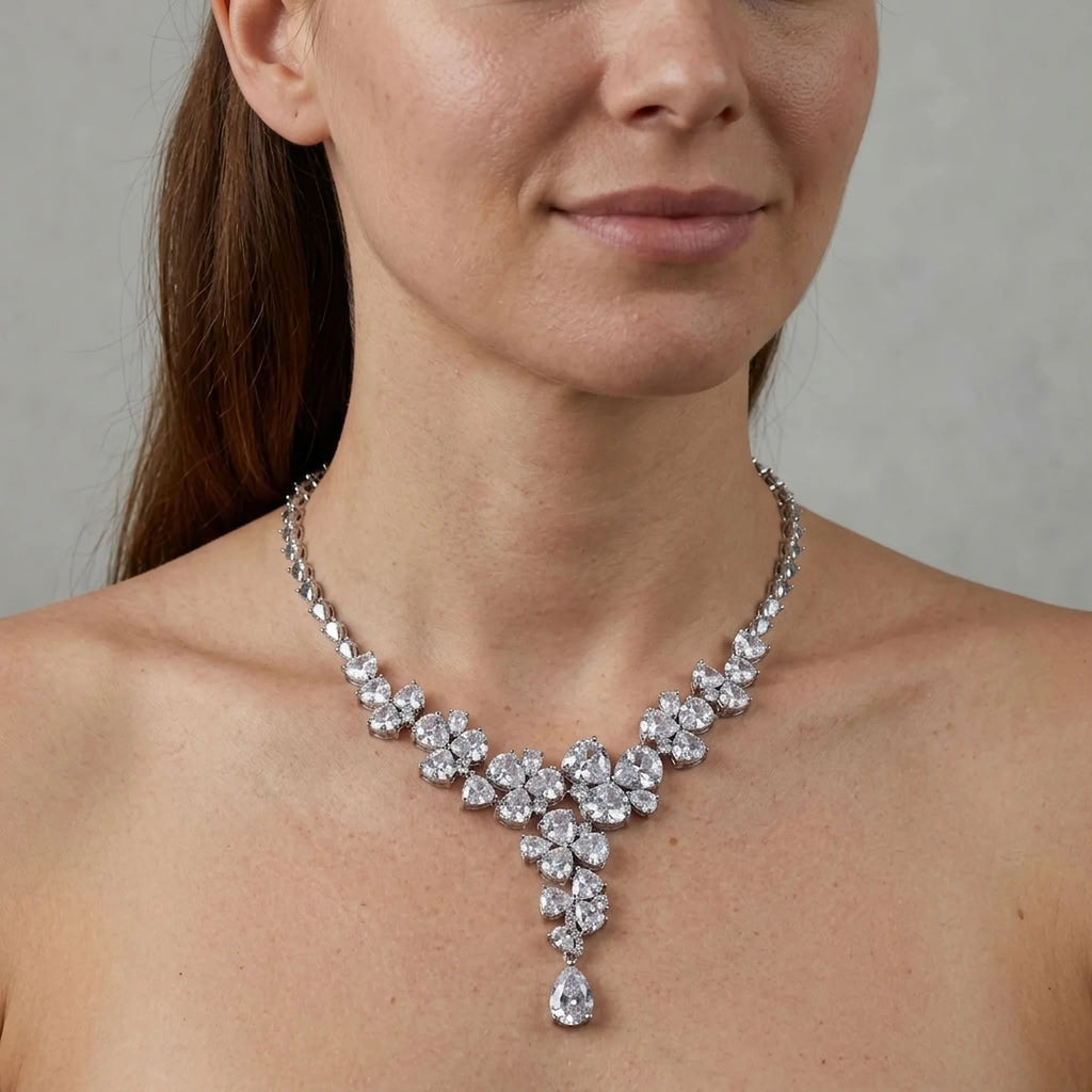 Woman wearing a bridal rhodium-plated cubic zirconia floral Y-drop necklace indoors in Dubai.
