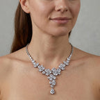 Woman wearing a bridal rhodium-plated cubic zirconia floral Y-drop necklace indoors in Dubai.