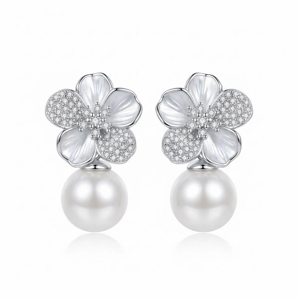 Front view of sculpted floral silver earrings with a suspended pearl drop on a white background.