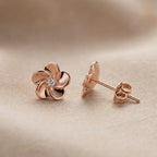 Rose gold flower stud earring face and push back closure detail on blush fabric — 925 sterling silver uae