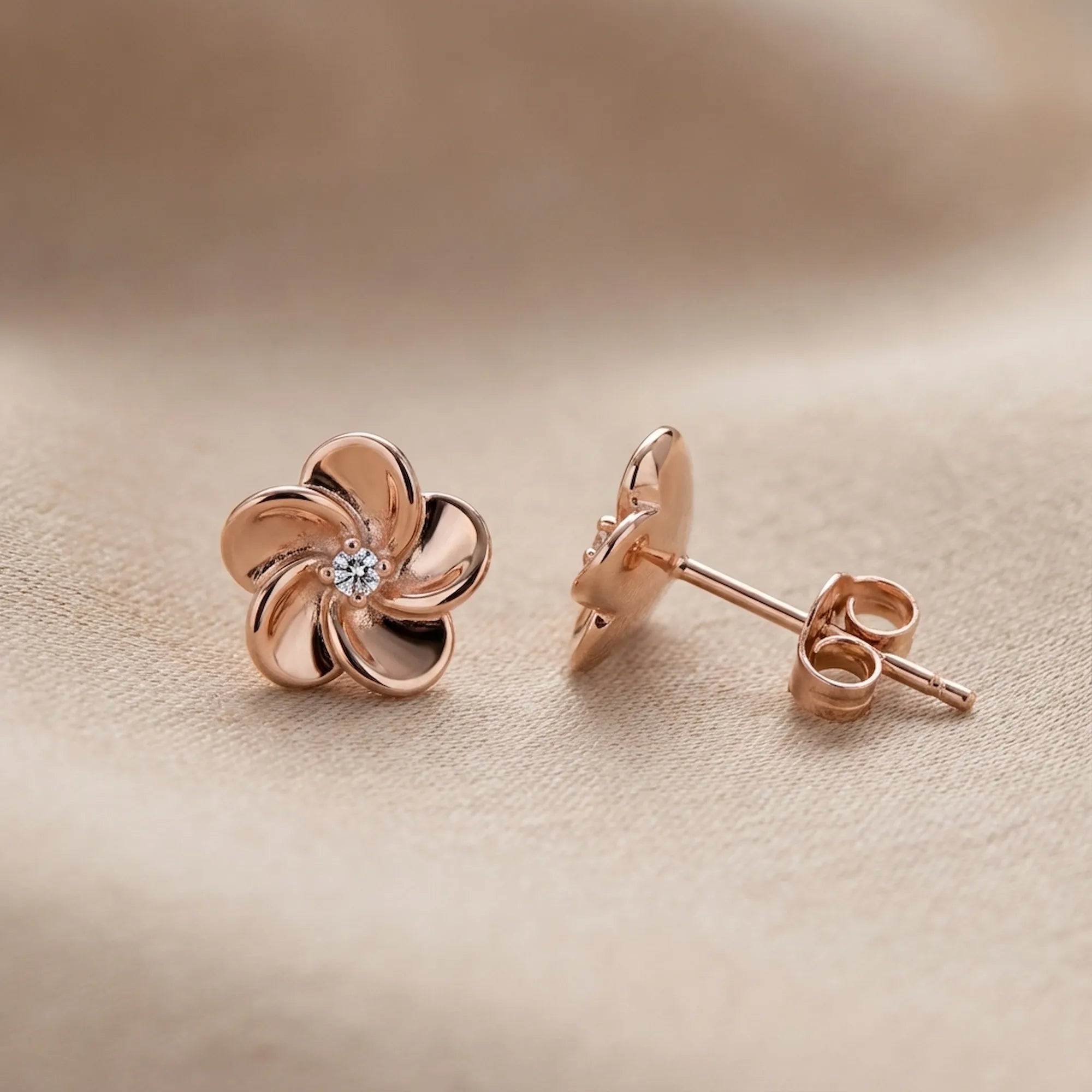 Rose gold flower stud earring face and push back closure detail on blush fabric — 925 sterling silver uae
