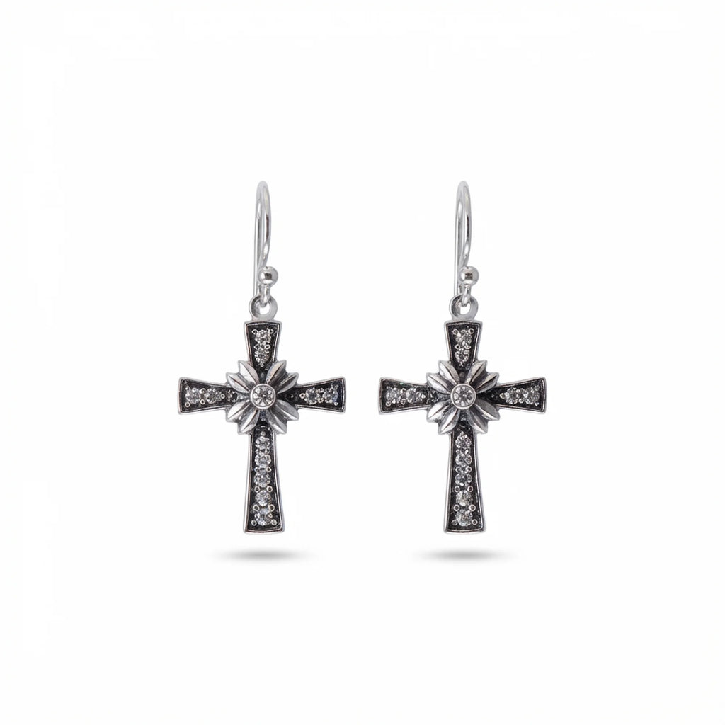 Oxidised 925 sterling silver floriated cross dangle earrings with pavé rhinestones on white background — French hook drop