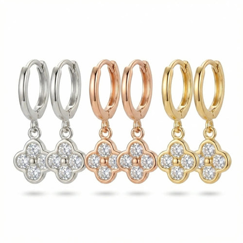 Three finishes of four-leaf clover huggie hoop earrings — silver, rose gold and gold in Dubai.