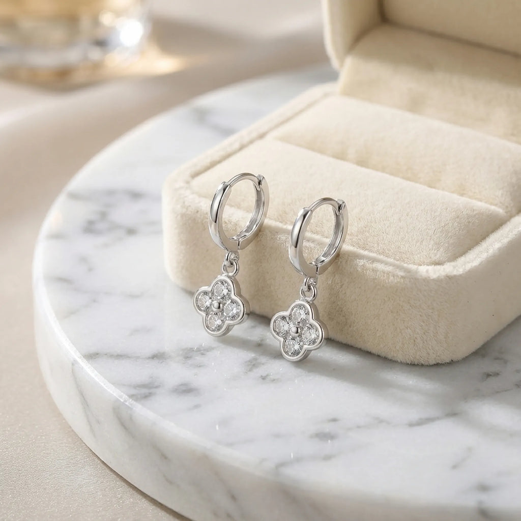 Silver four-leaf clover huggie hoop earrings with cubic zirconia in 925 sterling silver, Luna Dura Dubai