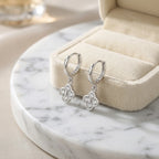 Silver four-leaf clover huggie hoop earrings with cubic zirconia in 925 sterling silver, Luna Dura Dubai