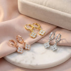 Four-leaf clover huggie hoop earrings in silver, gold and rose gold finishes, Luna Dura Dubai.