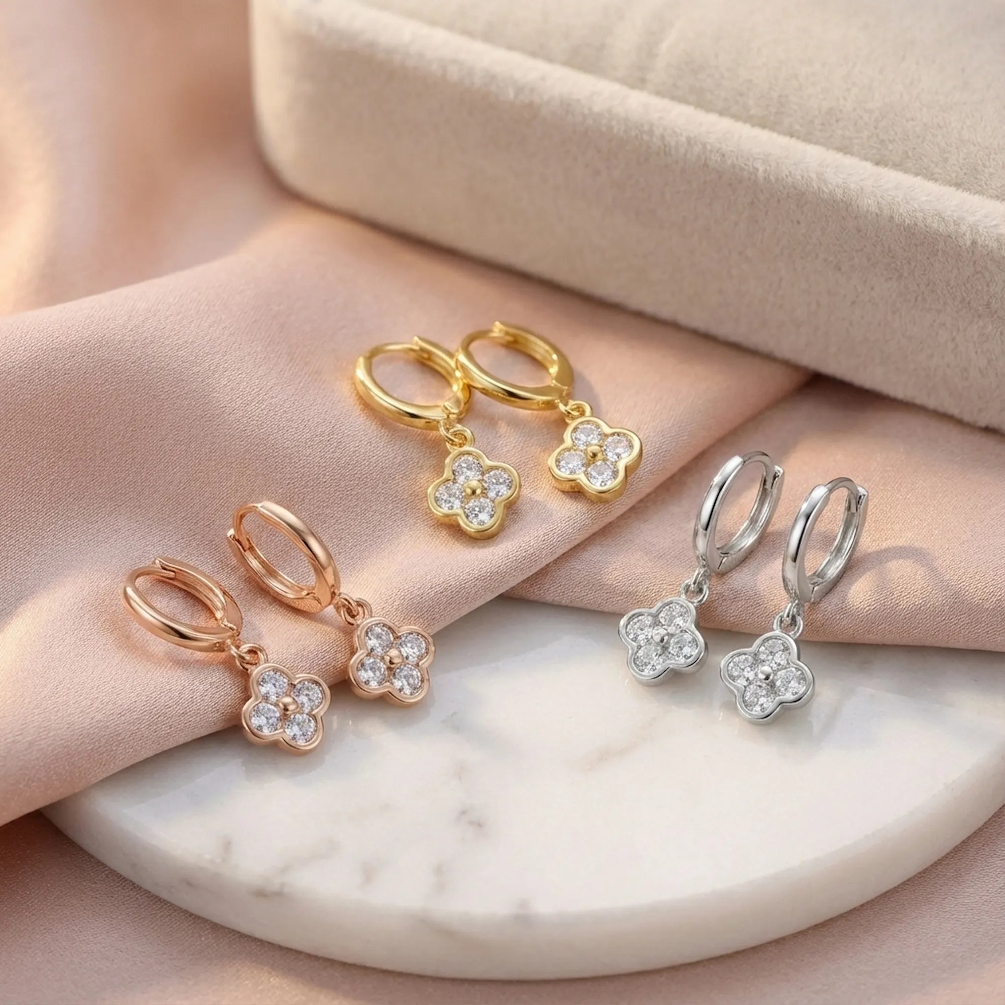 Four-leaf clover huggie hoop earrings in silver, gold and rose gold finishes, Luna Dura Dubai.