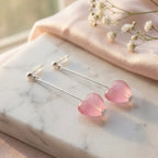 Pink heart silver drop earrings on marble with blush satin, soft-girl flat lay, Luna Dura Dubai