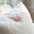 Pink heart silver drop earrings on white linen, soft-girl coquette styling, Luna Dura Dubai