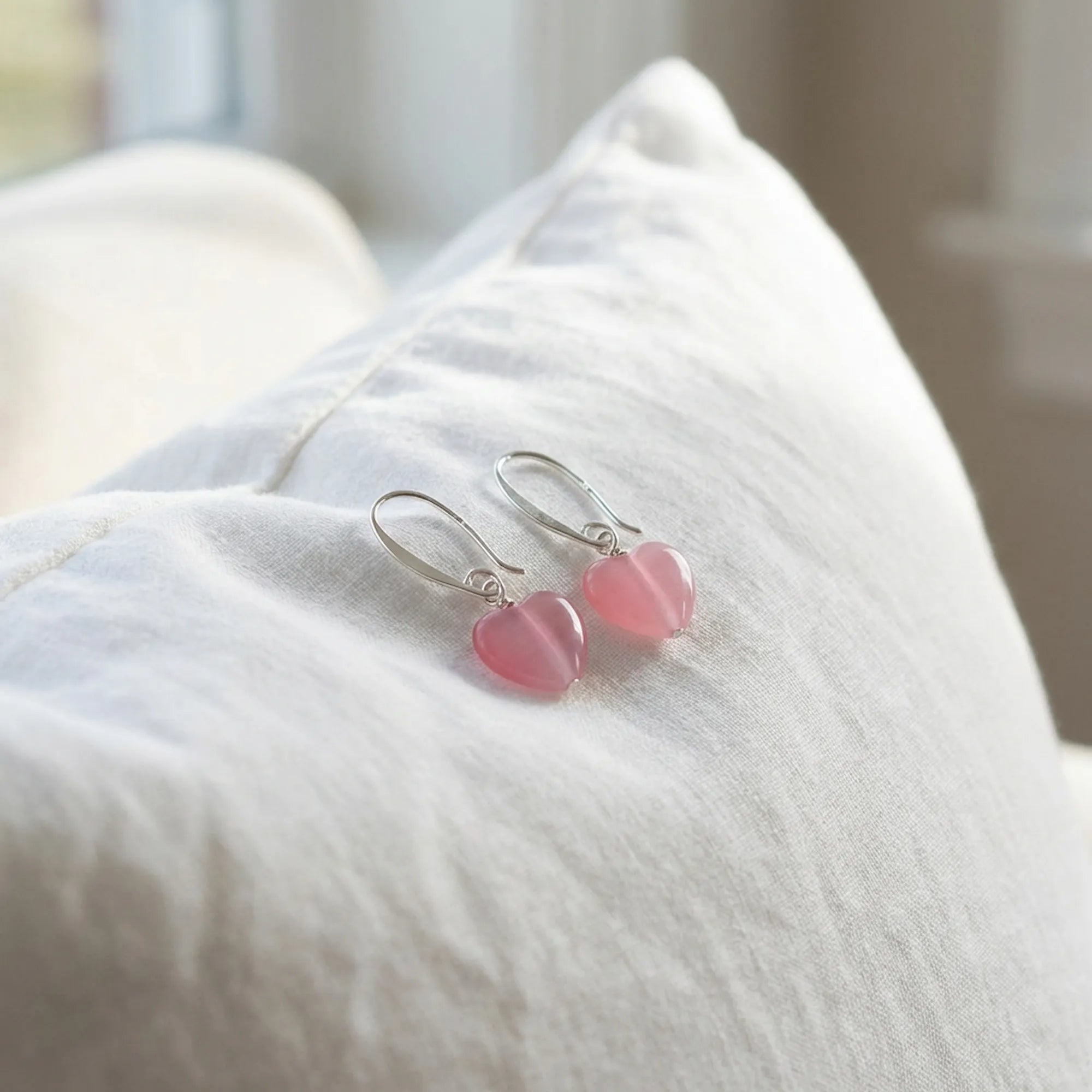 Pink heart silver drop earrings on white linen, soft-girl coquette styling, Luna Dura Dubai