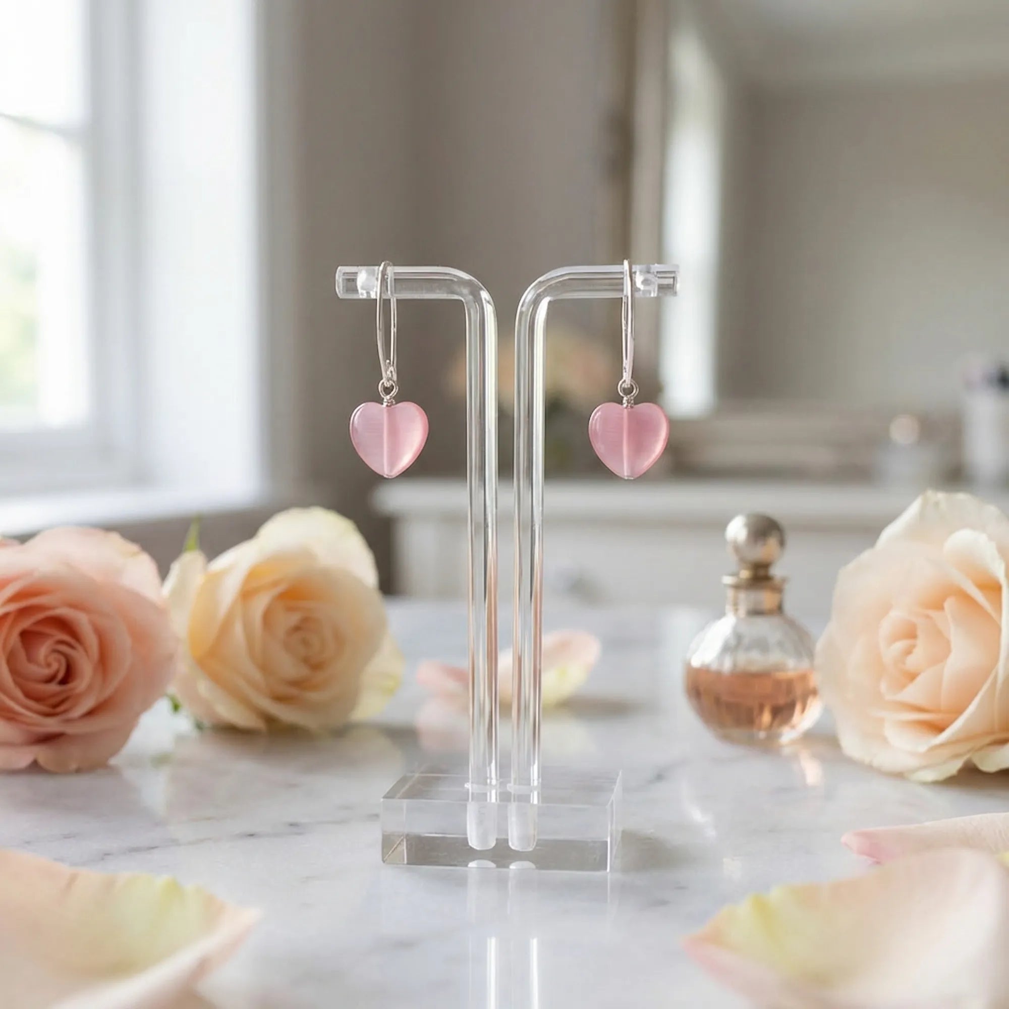 Frosted pink heart drop earrings on a stand with roses, romantic gift styling, Luna Dura Dubai