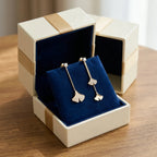 Folia Lucida ginkgo earrings in 18K gold in cream gift box with navy velvet cushion insert