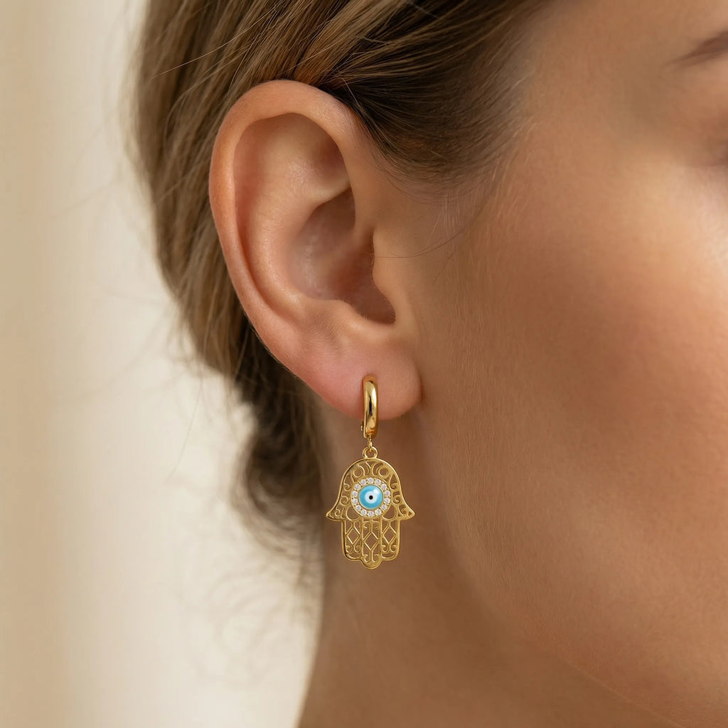 Gold Hamsa evil eye huggie hoop earring with CZ halo worn on the ear, gold-plated silver, Luna Dura Dubai