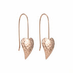 Hammered rose gold heart drop earrings in 925 sterling silver — elongated tapered heart form and wire fish hook on white background