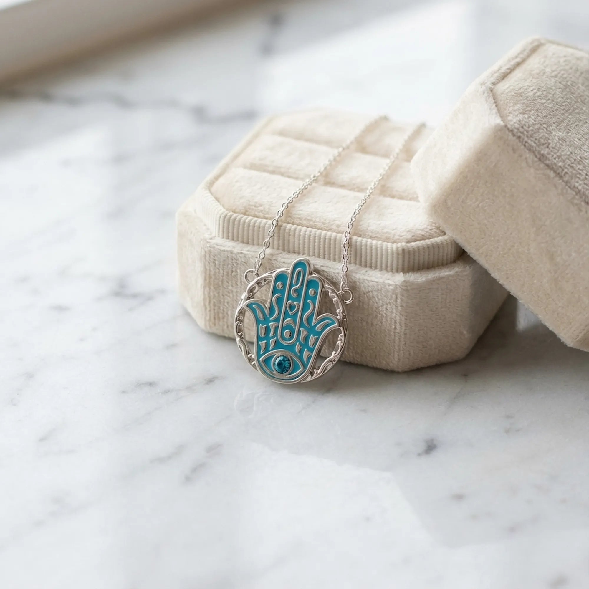 Hamsa blue topaz pendant necklace in a cream velvet gift box, 925 sterling silver, Luna Dura Dubai.