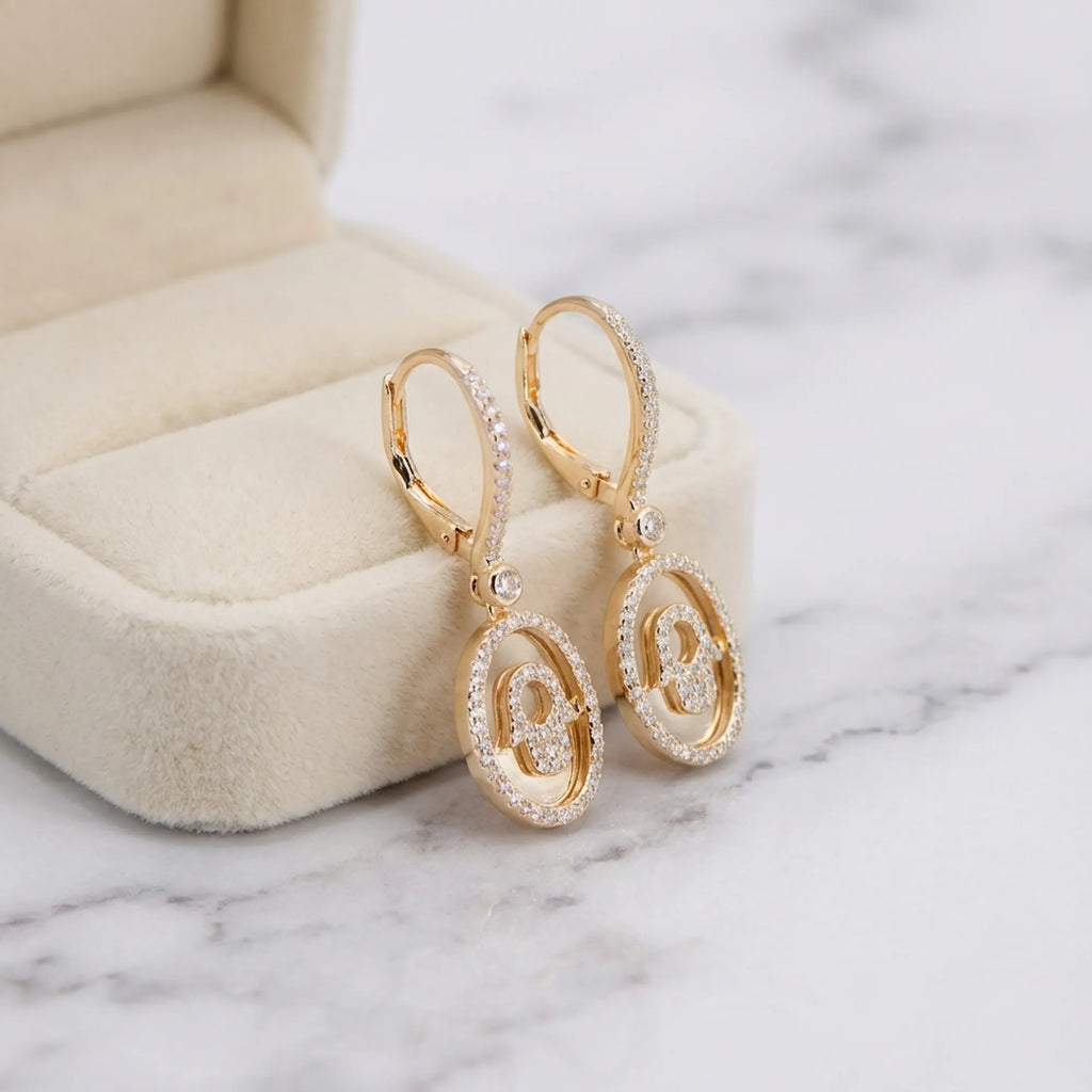 Hamsa drop earrings in 18K gold finish inside cream velvet jewelry box — meaningful gift Dubai UAE
