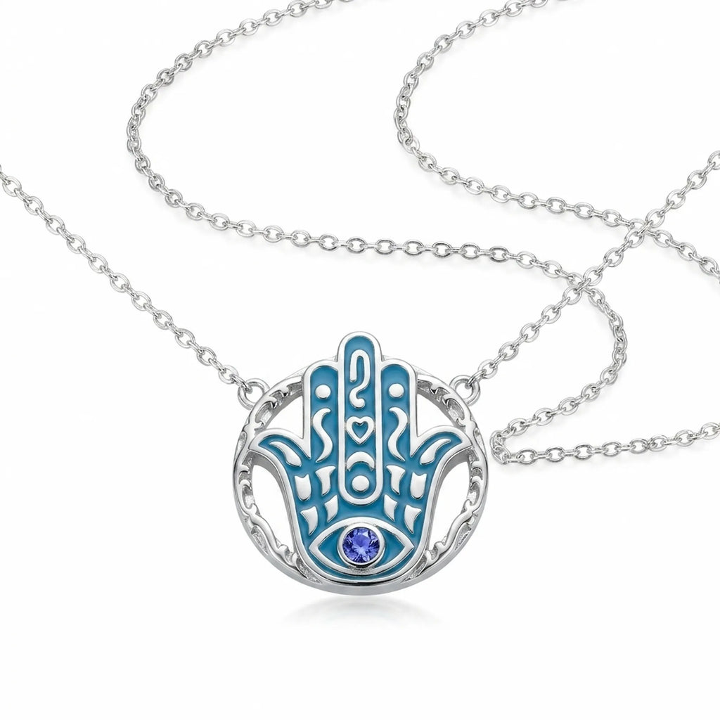 Hamsa hand pendant necklace in 925 sterling silver with azure blue enamel and a natural tanzanite eye, Luna Dura Dubai.