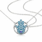 Hamsa hand pendant necklace in 925 sterling silver with azure blue enamel and a natural tanzanite eye, Luna Dura Dubai.