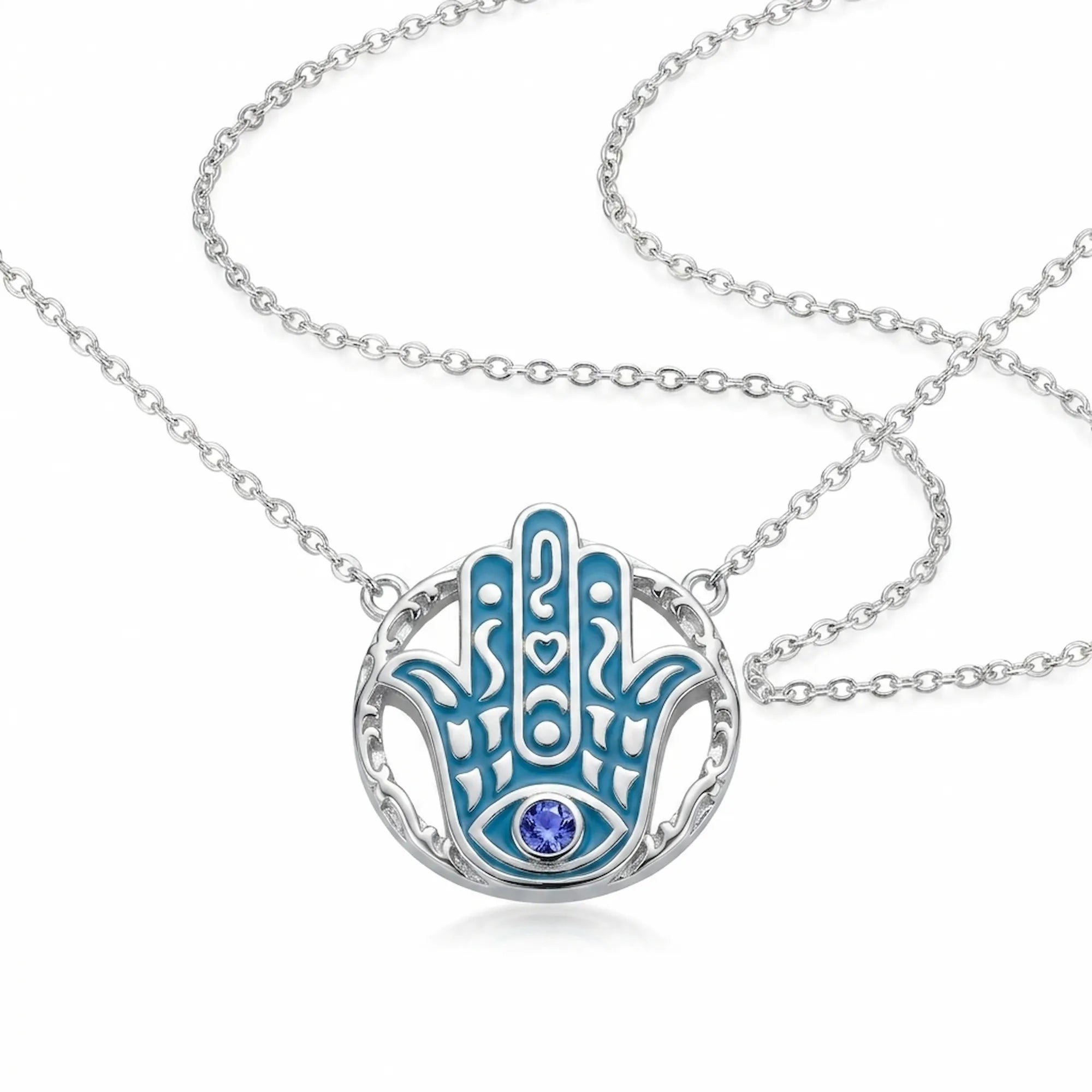Hamsa hand pendant necklace in 925 sterling silver with azure blue enamel and a natural tanzanite eye, Luna Dura Dubai.
