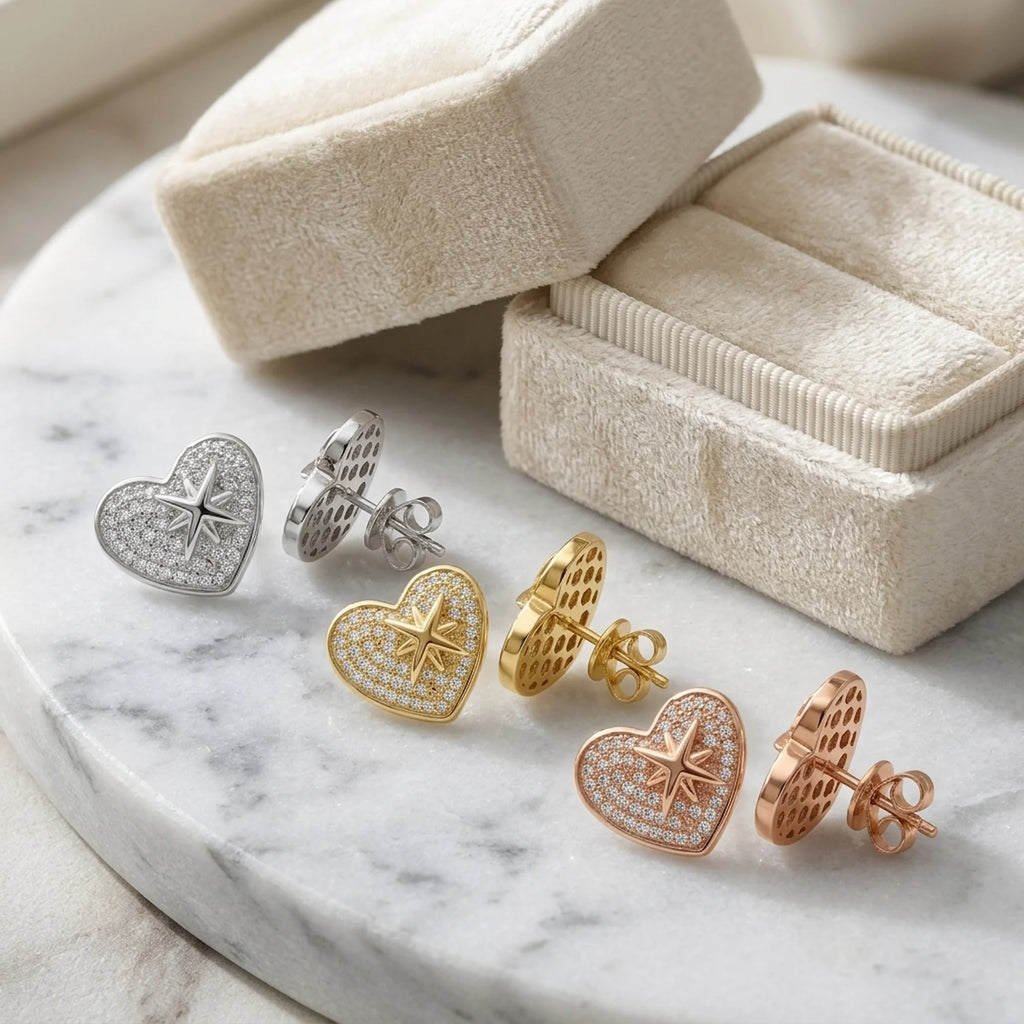 Three pairs of 925 silver pavé heart earrings with cubic zirconia displayed in a jewelry box in Dubai.