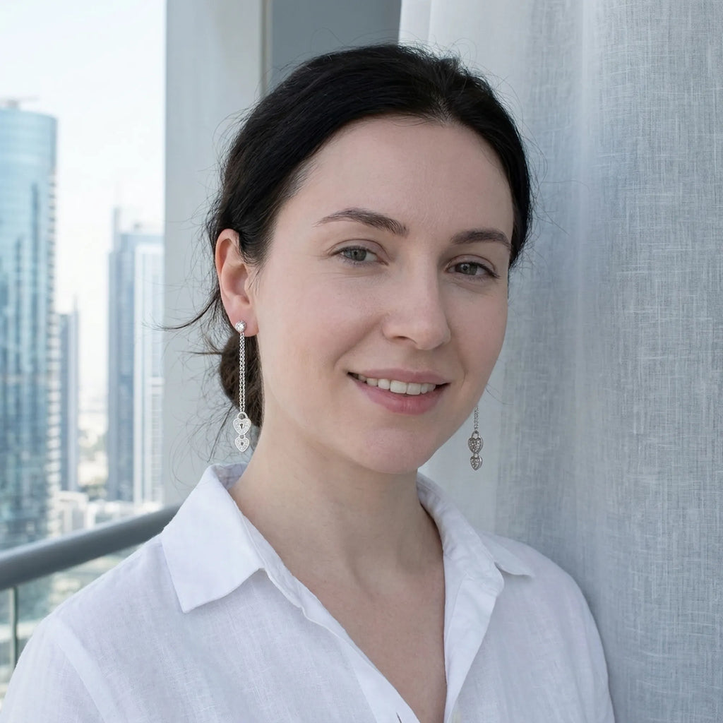 Model wearing heart lock drop earrings at Dubai Marina — full double lock cascade visible against high-rise skyline, rhodium 925 silver Dubai